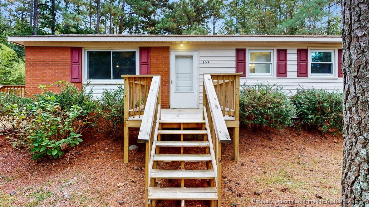 164 Happy Valley Road West End, NC 27376 - Photo 2 of 17 front view of house with a yard