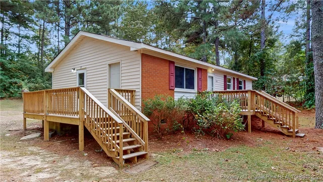 a view of a house with a yard and sitting area