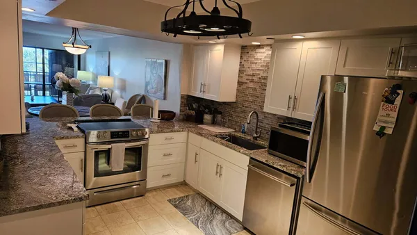 a kitchen with stainless steel appliances a stove a sink and a refrigerator