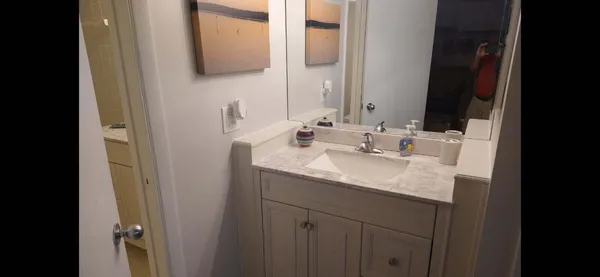 a bathroom with a sink and a mirror