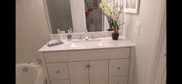 a bathroom with a sink vanity and a mirror
