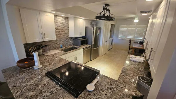 a kitchen with sink refrigerator and window