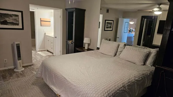 a bedroom with a bed a mirror and a desk