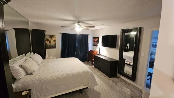 a bedroom with a bed and a large mirror in a closet