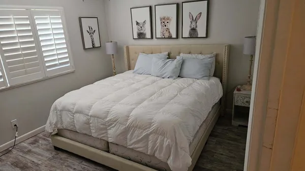 a bed sitting in a bedroom next to a window