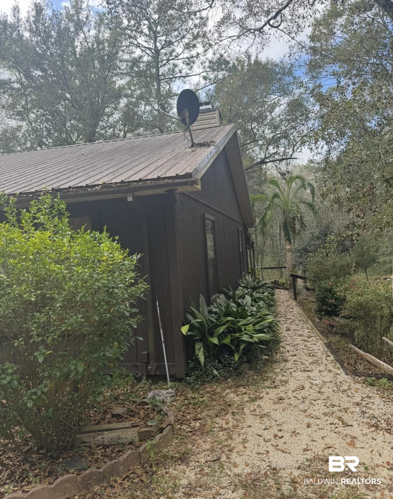 23341 County Road 49 Silverhill, AL 36576 - Photo 2 of 23 View of property exterior featuring a metal roof
