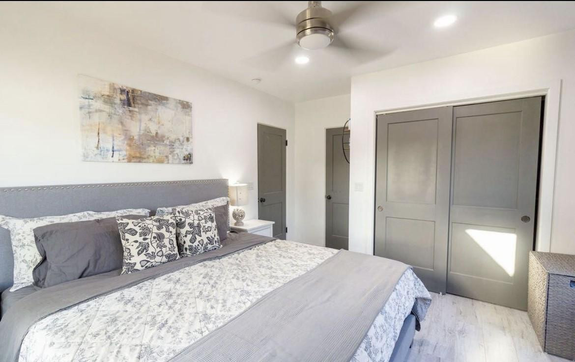 4214 North 20th Street Phoenix, AZ 85016 - Photo 20 of 40 a bedroom with a large bed and a chandelier
