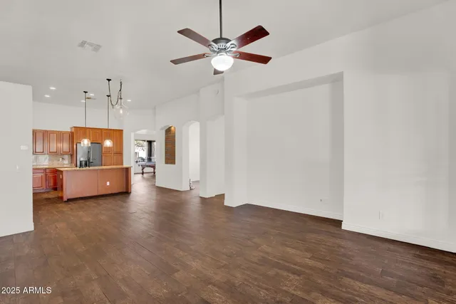 a view of an empty room with a ceiling fan