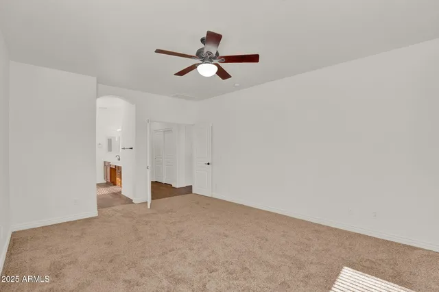 a view of empty room with ceiling fan