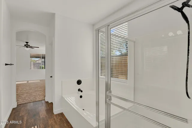 a bathroom with a bathtub and a shower