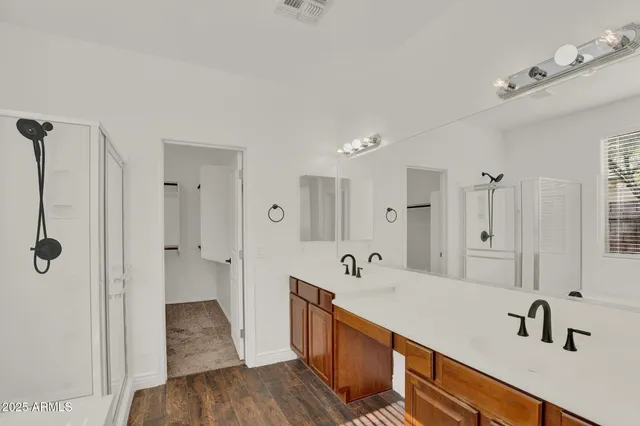 a spacious bathroom with a tub sink and mirror
