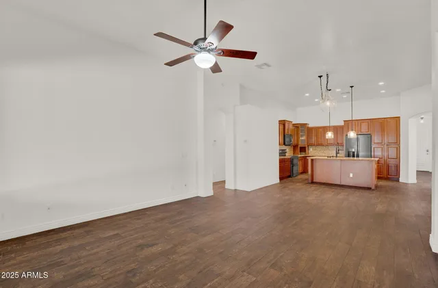 a view of a kitchen with a sink and dishwasher cabinet with wooden floor