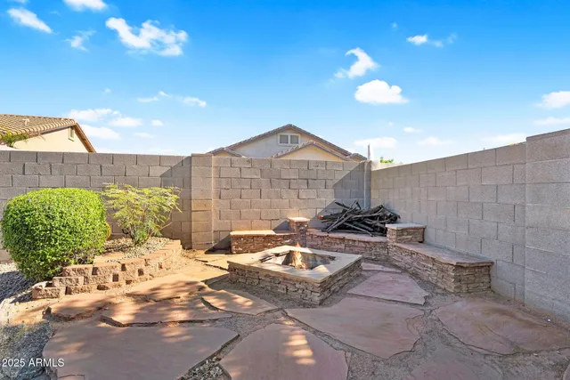 a view of a patio with table and chairs with an umbrella