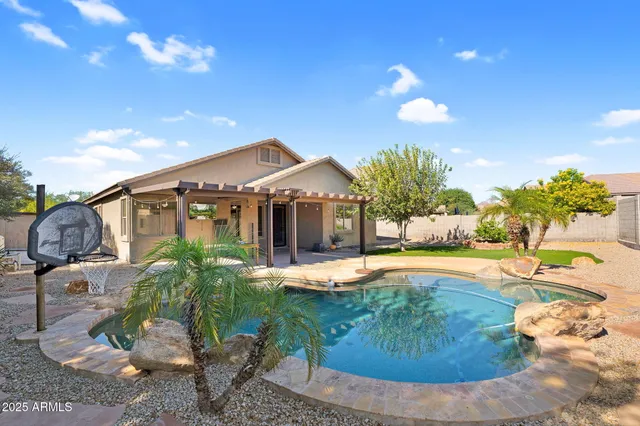 a view of a house with swimming pool yard and sitting area
