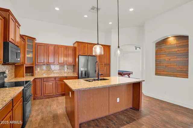 a kitchen with a sink stove and cabinets