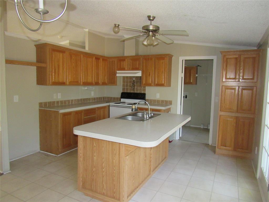 40 Cleveland Avenue Pottsboro, TX 75076 - Photo 12 of 29 a view of a kitchen with kitchen island a sink stainless steel appliances and cabinets