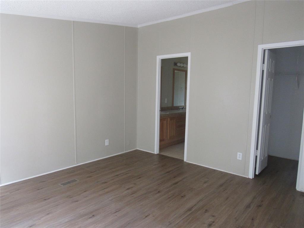 40 Cleveland Avenue Pottsboro, TX 75076 - Photo 16 of 29 a view of an empty room with wooden floor and closet
