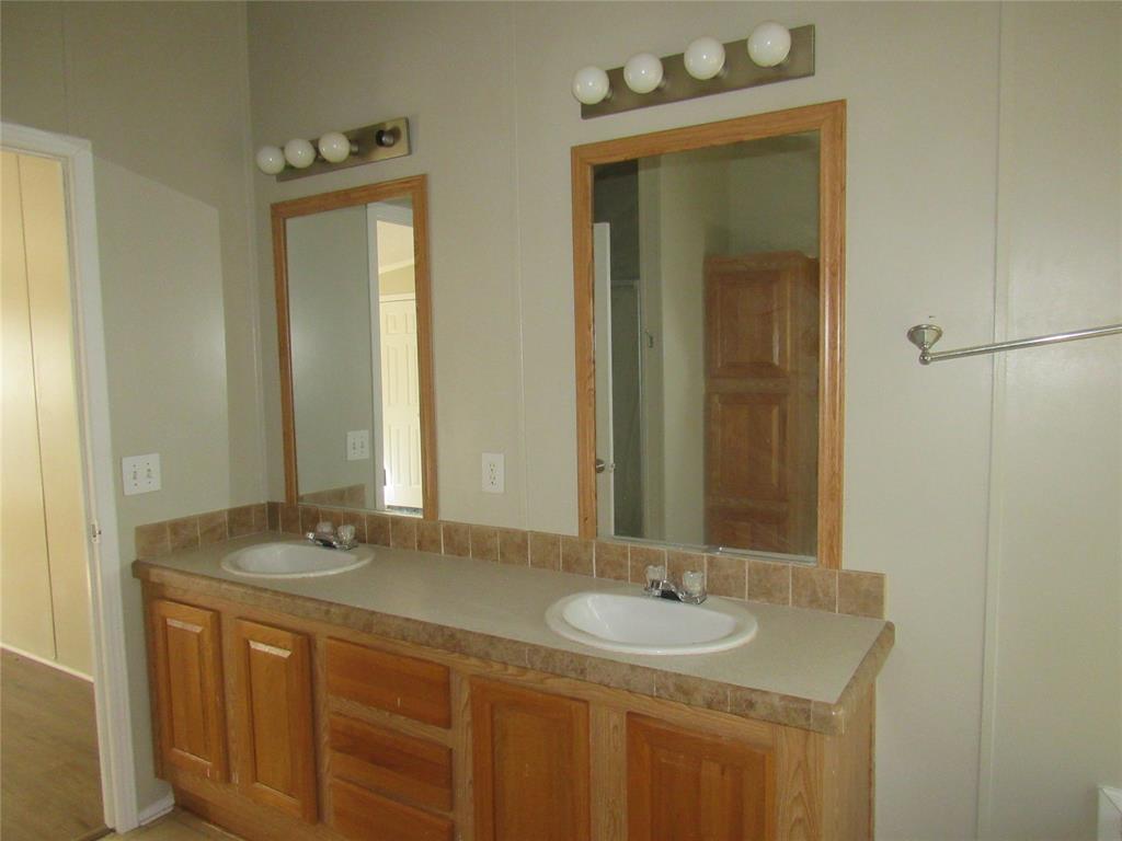 40 Cleveland Avenue Pottsboro, TX 75076 - Photo 18 of 29 a bathroom with a granite countertop sink and a mirror