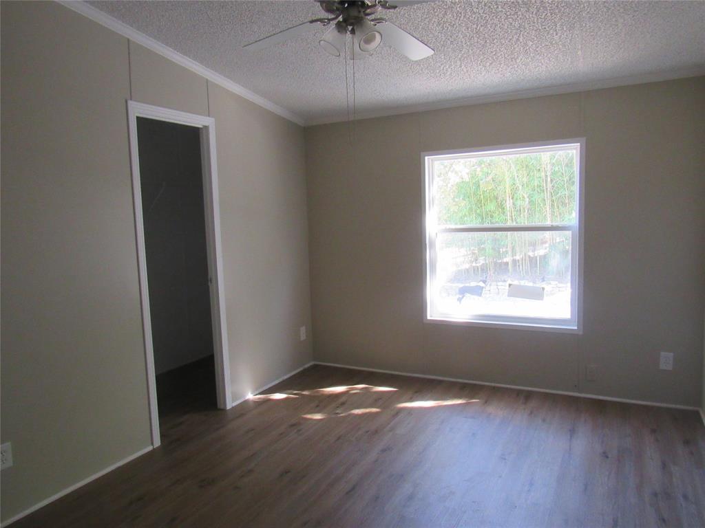 40 Cleveland Avenue Pottsboro, TX 75076 - Photo 22 of 29 an empty room with wooden floor and windows