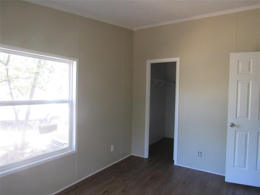 40 Cleveland Avenue Pottsboro, TX 75076 - Photo 25 of 29 a view of an empty room with wooden floor and a window