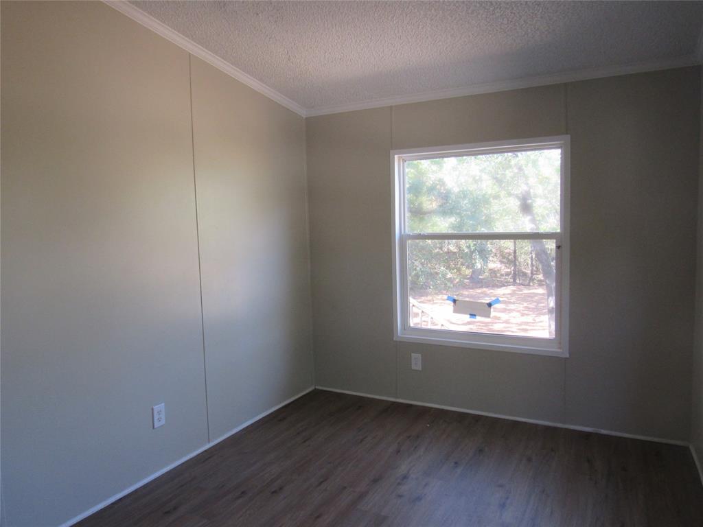 40 Cleveland Avenue Pottsboro, TX 75076 - Photo 26 of 29 an empty room with wooden floor and windows