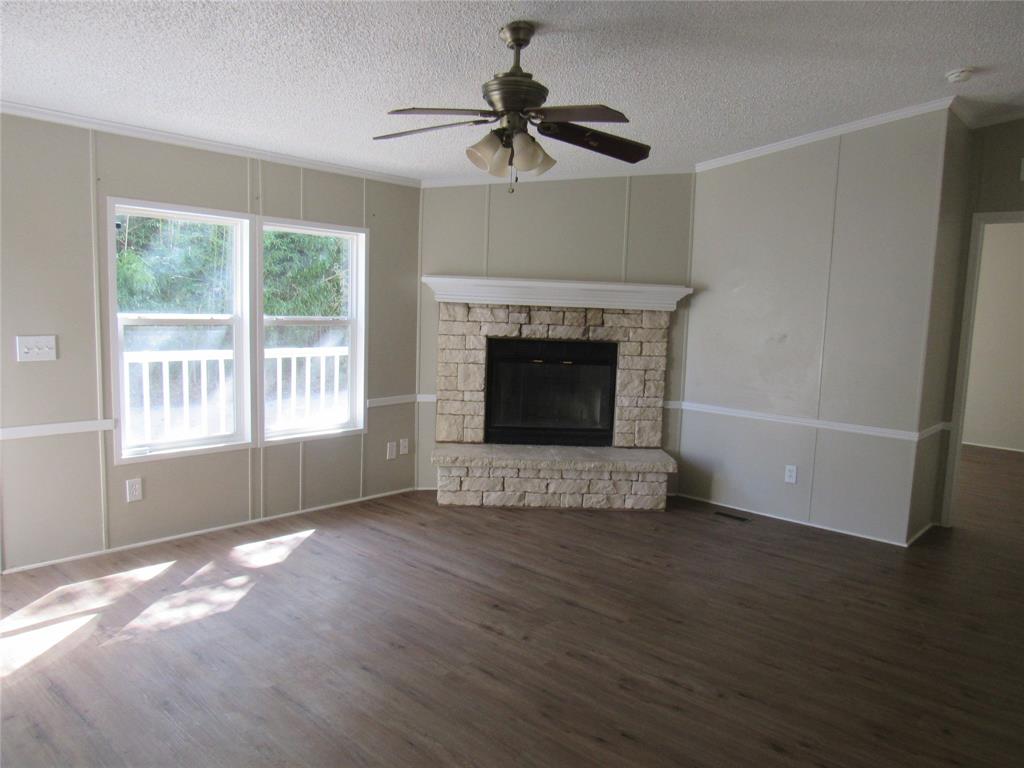 40 Cleveland Avenue Pottsboro, TX 75076 - Photo 10 of 29 a view of an empty room with wooden floor fireplace and a window