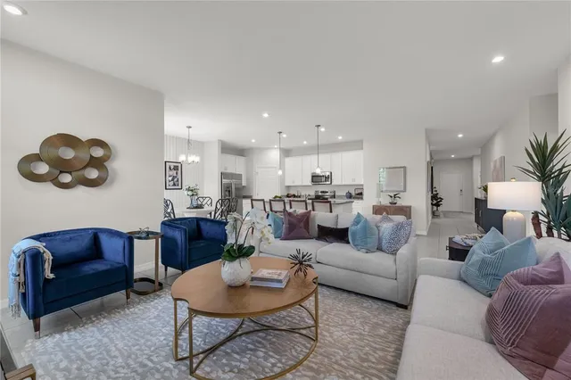 a living room with furniture kitchen view and a table