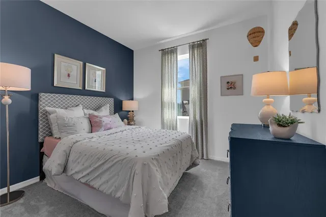 a bedroom with a bed and a lamp