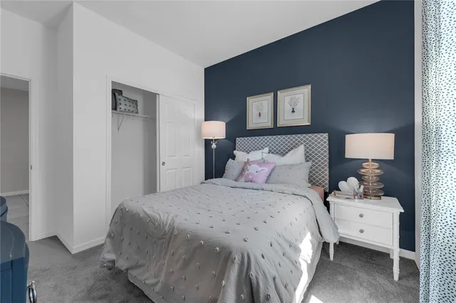 a bedroom with a bed and a night stand