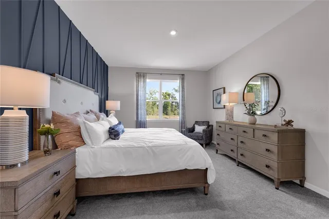 a bedroom with a bed a dresser and window