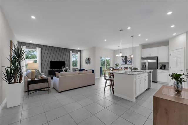 a living room with furniture and a kitchen