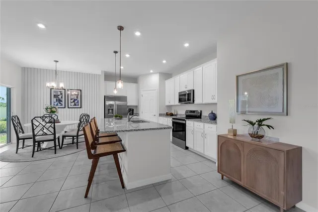 a living room with furniture a dining table and kitchen view