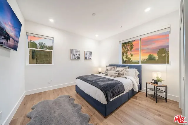 a bed room with a bed and a painting