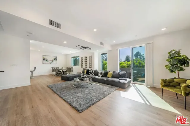 a living room with fireplace furniture and a potted plant