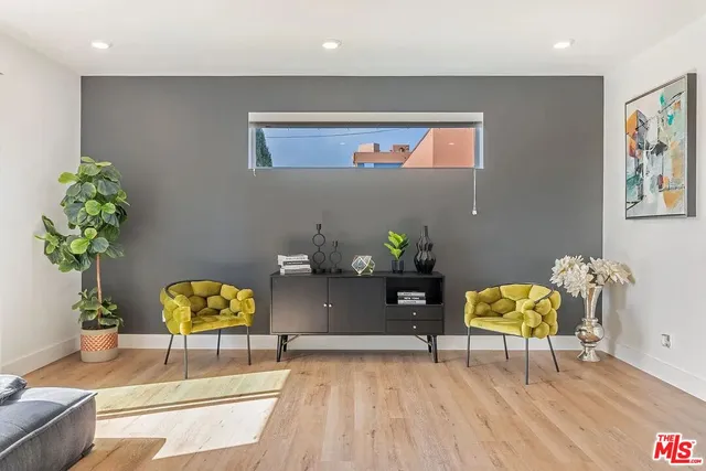 a living room with furniture and a potted plant