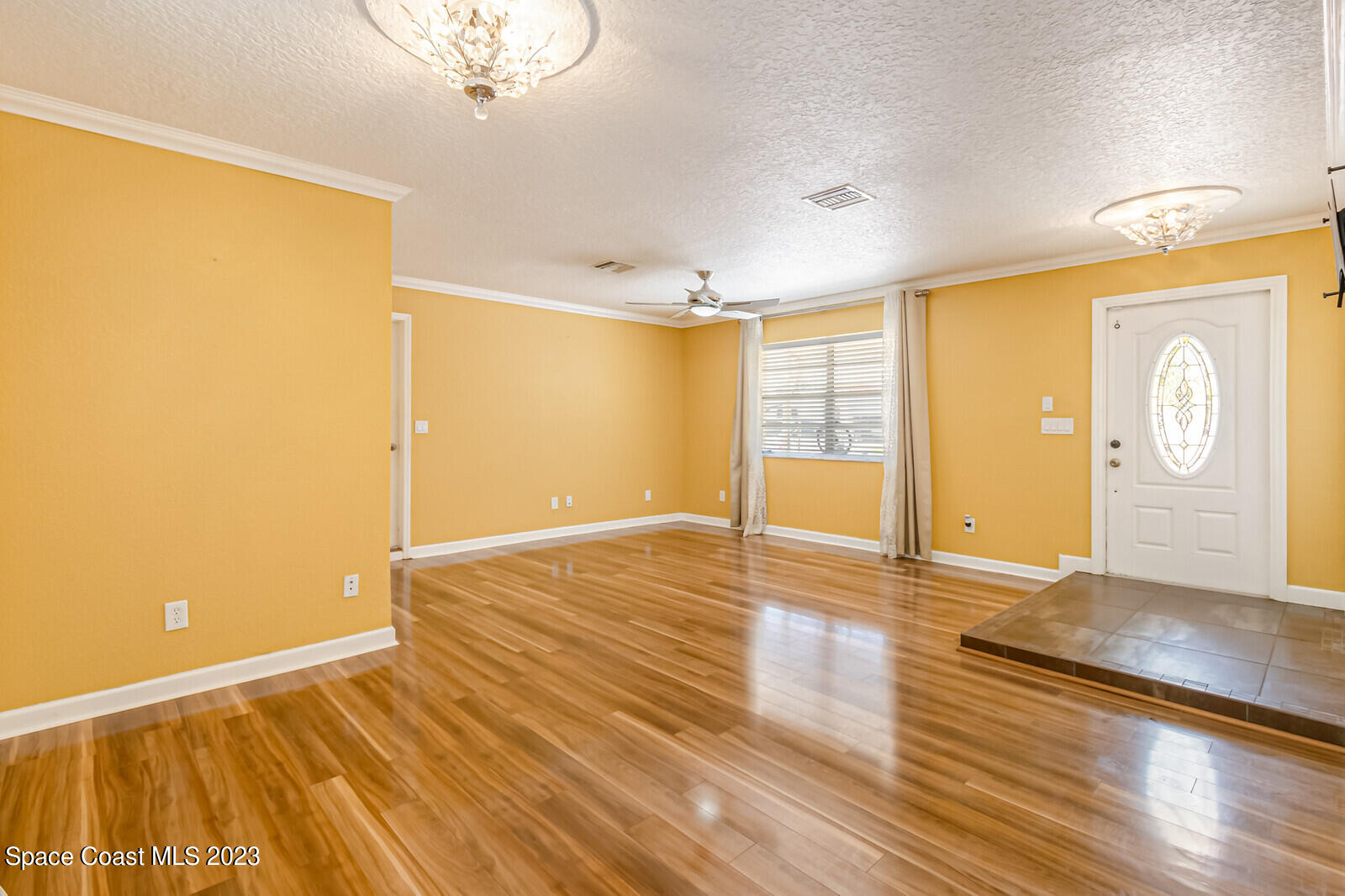 2567 Wright Avenue Melbourne, FL 32935 - Photo 14 of 36 a view of an empty room with wooden floor and a window