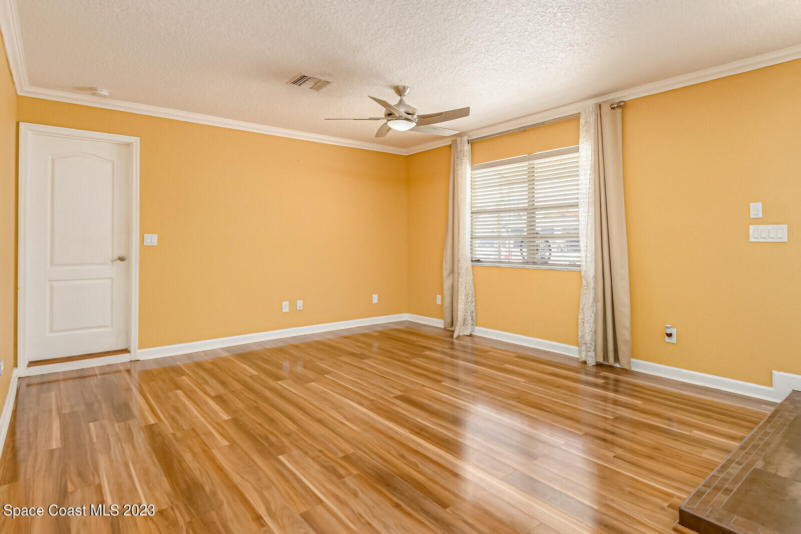 2567 Wright Avenue Melbourne, FL 32935 - Photo 16 of 36 a view of an empty room with wooden floor and a window