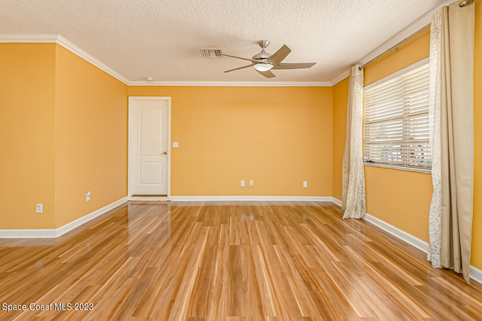 2567 Wright Avenue Melbourne, FL 32935 - Photo 17 of 36 wooden floor in an empty room with a window