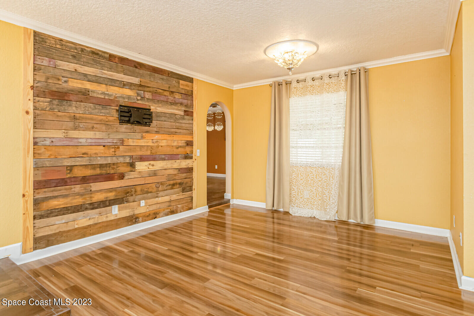 2567 Wright Avenue Melbourne, FL 32935 - Photo 19 of 36 a view of an empty room with wooden floor and a window