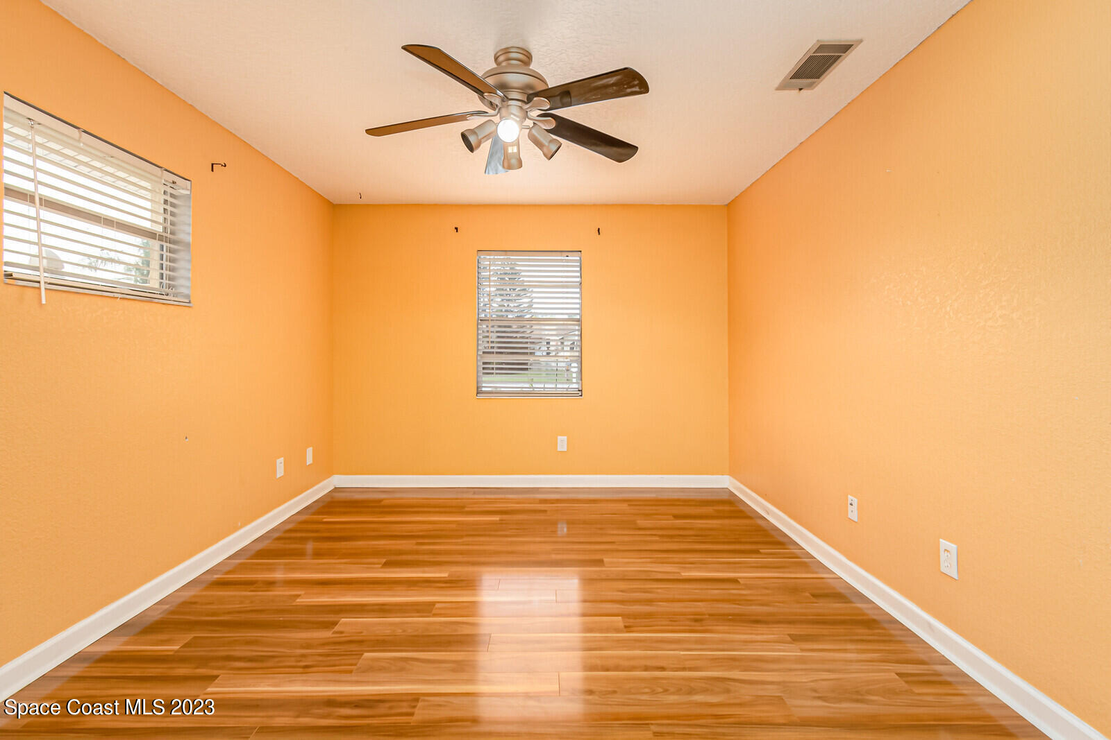 2567 Wright Avenue Melbourne, FL 32935 - Photo 22 of 36 a view of an empty room with wooden floor and a window