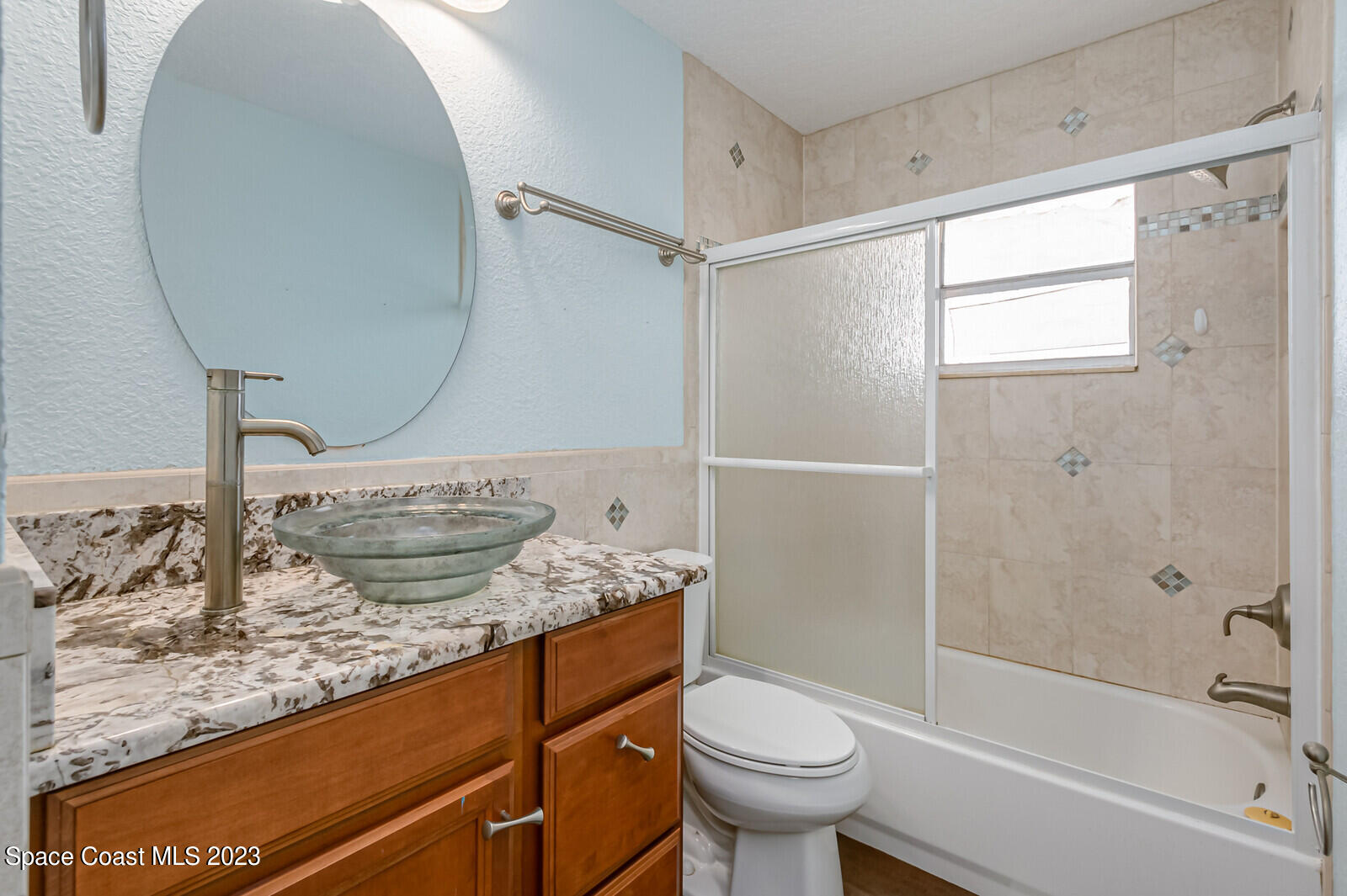 2567 Wright Avenue Melbourne, FL 32935 - Photo 24 of 36 a bathroom with a granite countertop sink toilet and shower