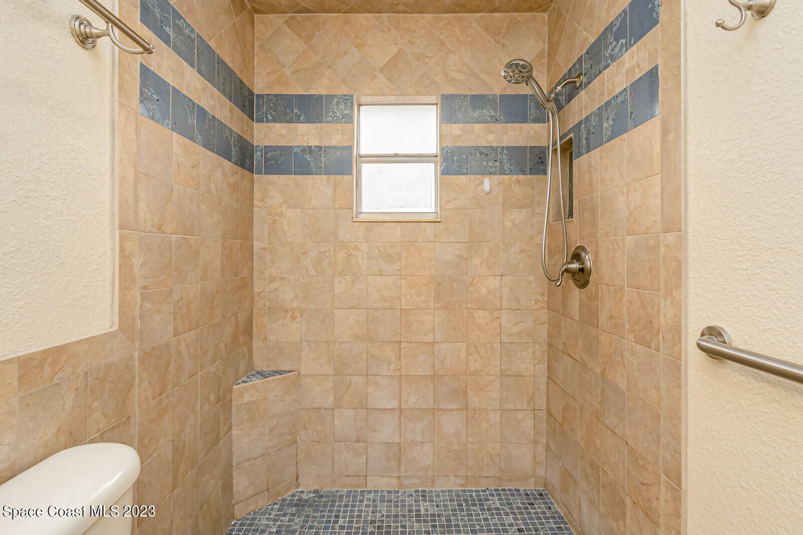 2567 Wright Avenue Melbourne, FL 32935 - Photo 25 of 36 a bathroom with a shower and toilet