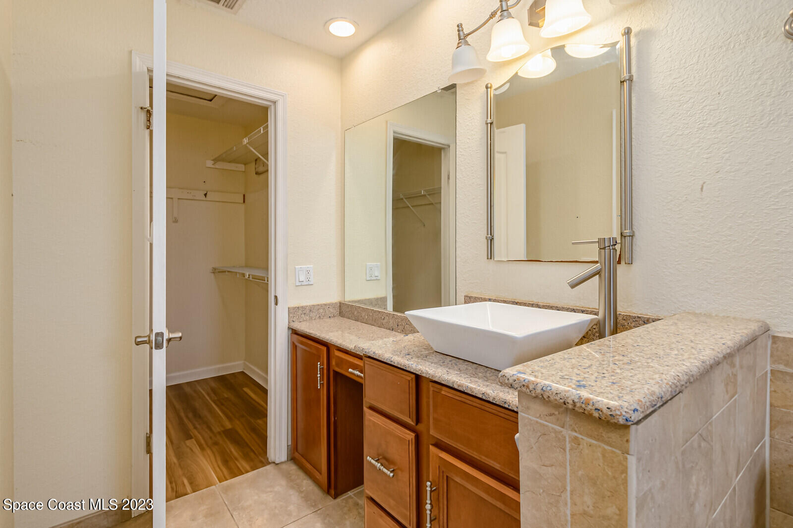 2567 Wright Avenue Melbourne, FL 32935 - Photo 27 of 36 a bathroom with a granite countertop sink and a mirror