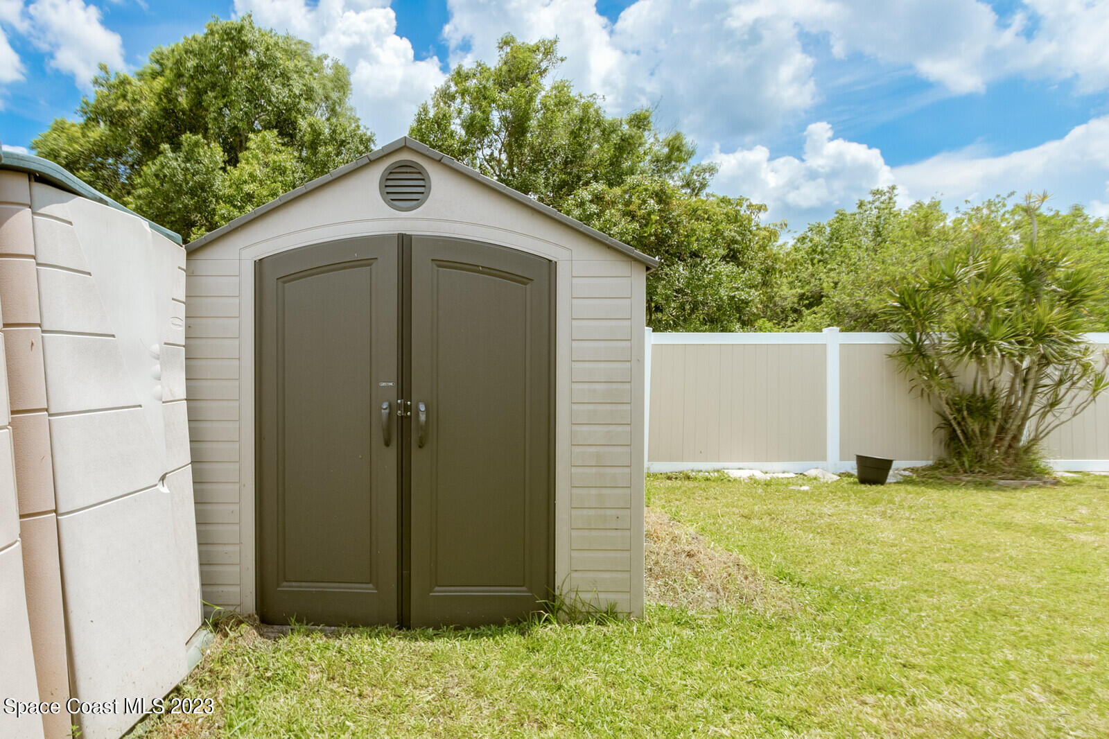 2567 Wright Avenue Melbourne, FL 32935 - Photo 32 of 36 a front view of a house with a yard