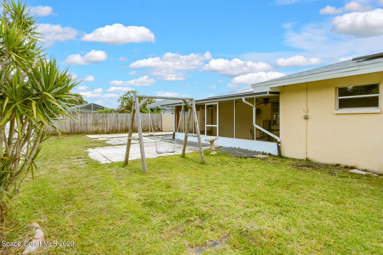 2567 Wright Avenue Melbourne, FL 32935 - Photo 34 of 36 a swimming pool with some trees in the background