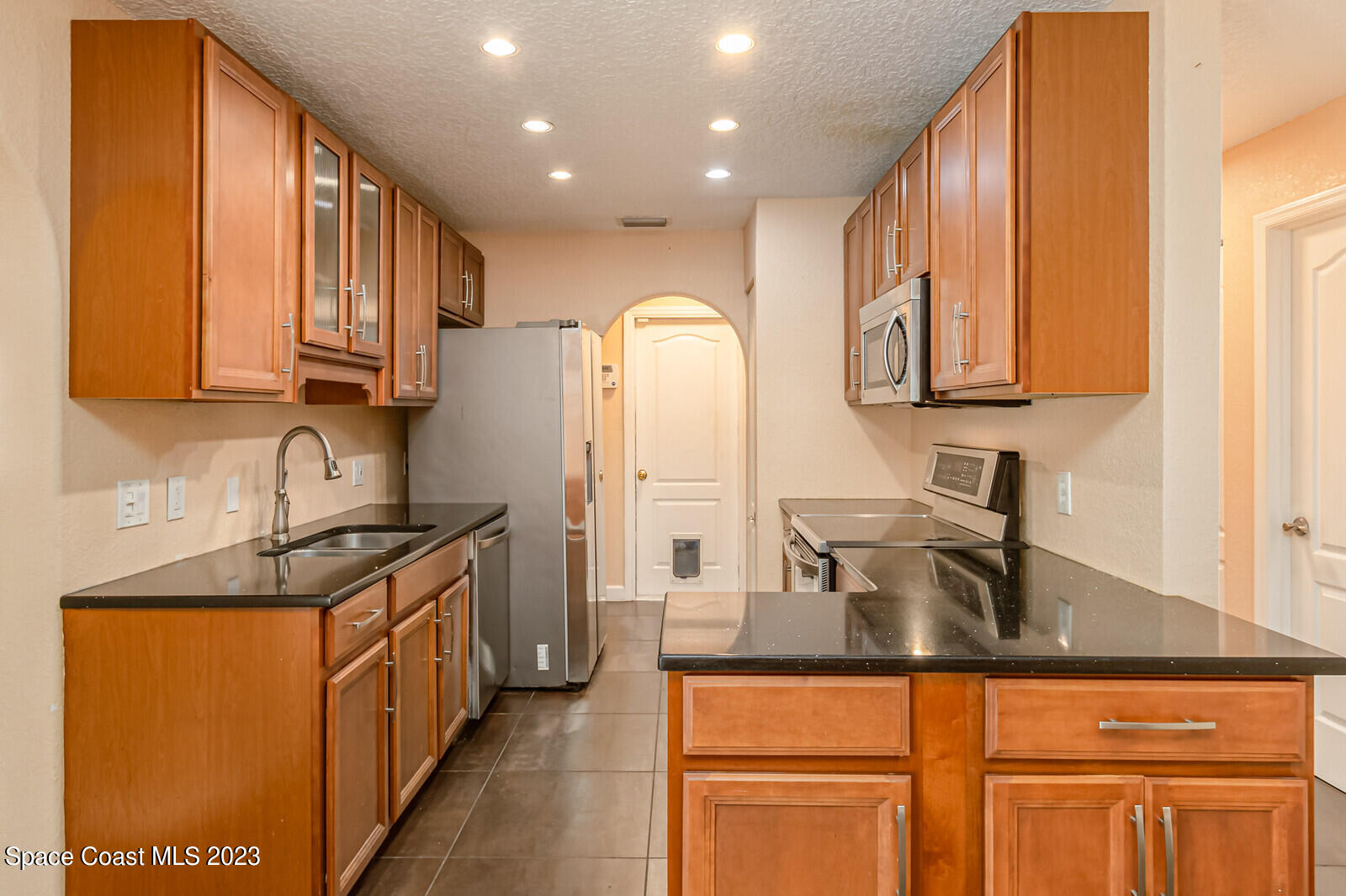 2567 Wright Avenue Melbourne, FL 32935 - Photo 6 of 36 a kitchen with granite countertop a sink and cabinets