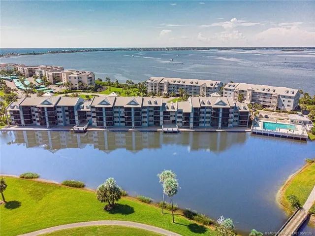 a front view of a building with palm trees