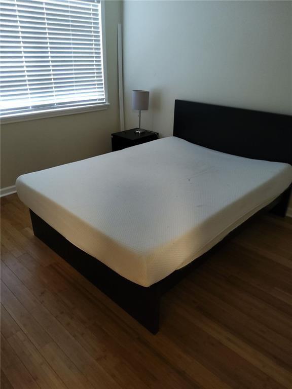 405 Fairburn Road Southwest, Unit 21 Atlanta, GA 30331 - Photo 12 of 16 a bed sitting in a bedroom next to a window