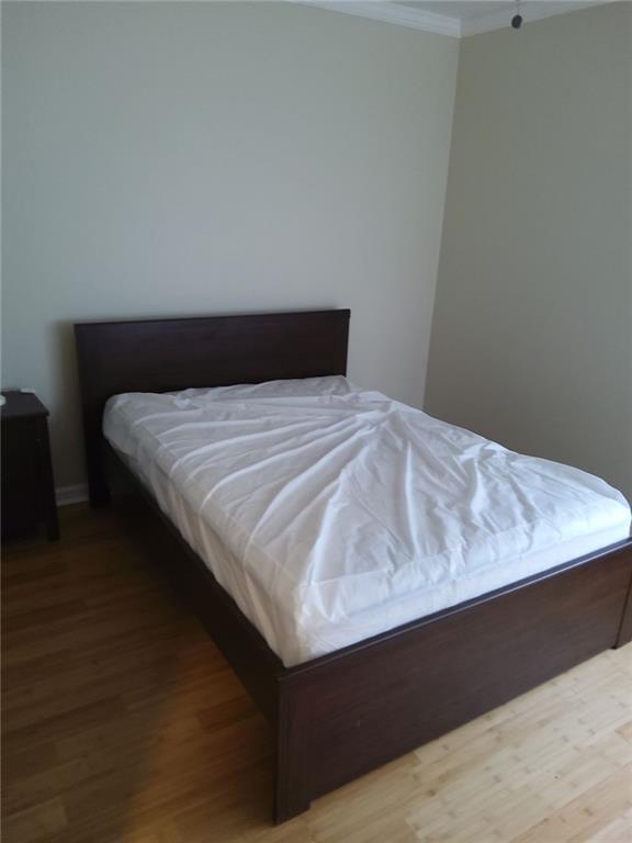 405 Fairburn Road Southwest, Unit 21 Atlanta, GA 30331 - Photo 15 of 16 a bed sitting in a bedroom next to a wooden cabinet