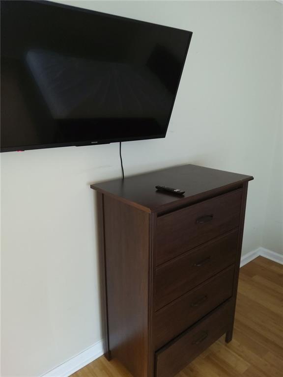 405 Fairburn Road Southwest, Unit 21 Atlanta, GA 30331 - Photo 16 of 16 a room with a black space and wooden floor